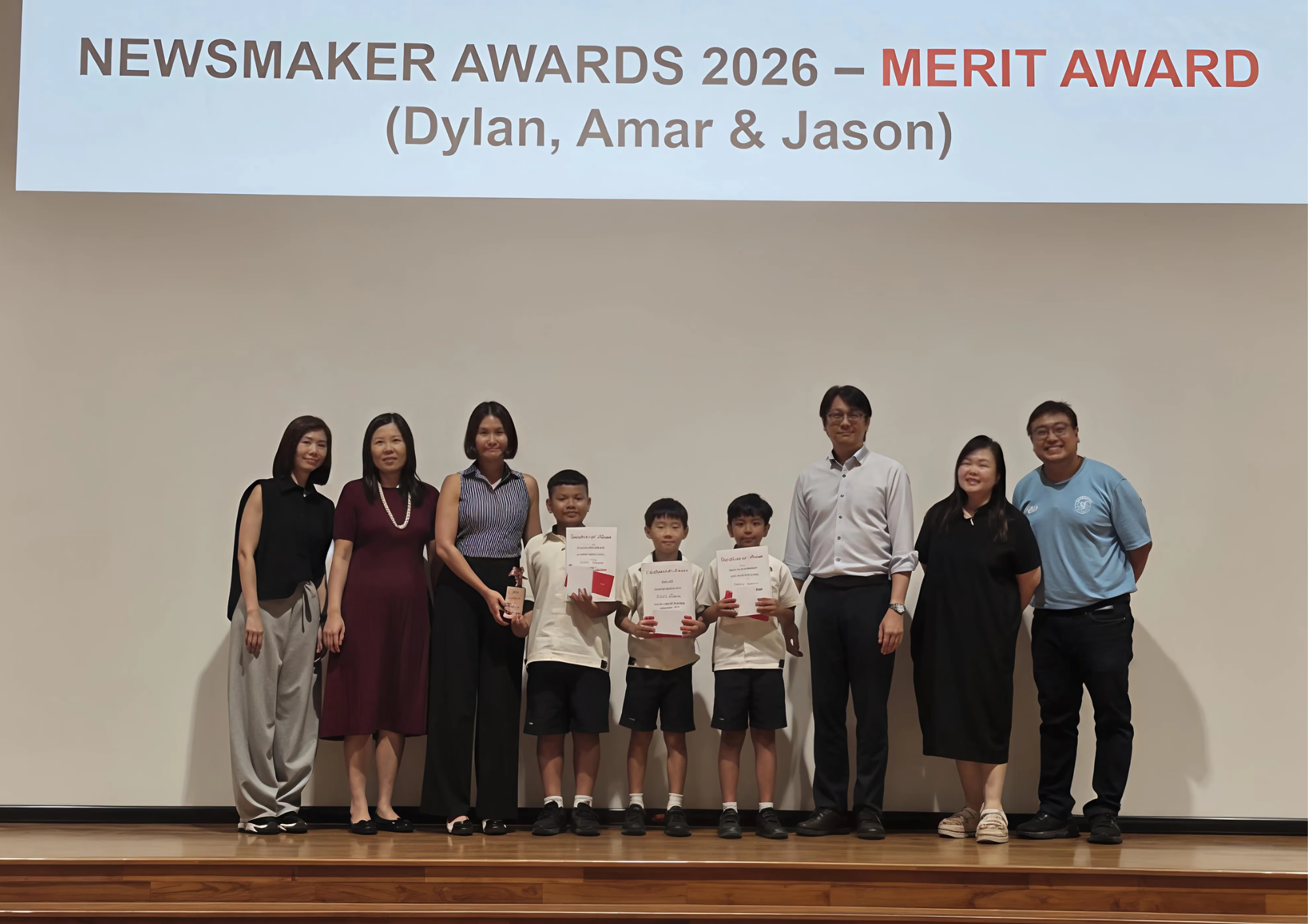 Winners of competition posing with teachers and school leaders in award ceremony
